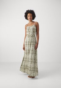 Maxi dress in a lightweight fabric. Features a green and white tie-dye pattern, adjustable spaghetti straps, and an elastic waist.