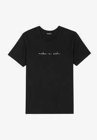 Black cotton t-shirt with short sleeves and a crew neck, featuring white cursive text “make a wish” on the front.