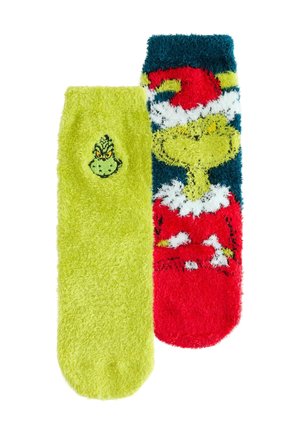 Colorful, fuzzy socks: one bright green with a Grinch face, the other red with white and green detailing depicting a Santa outfit.