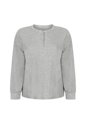 Lichtgrijs henley-shirt met lange mouwen. Geweven stof met een ronde hals en een knoopsluiting met vier knopen. Losse pasvorm, licht afgeronde zoom aan de onderkant.