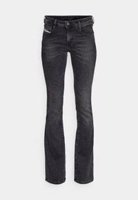 Czarne dżinsy o wąskim kroju, z delikatnym rozszerzeniem na dole, pięć kieszeni, z metalowym zapięciem oraz subtelnymi przetarciami na materiale.