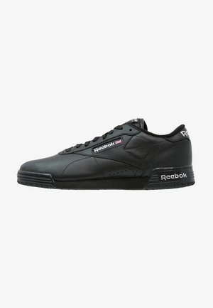 Black leather sneaker with flat sole, lace-up design, Reebok logo on side and tongue, textured accents, and minimal perforations for breathability.