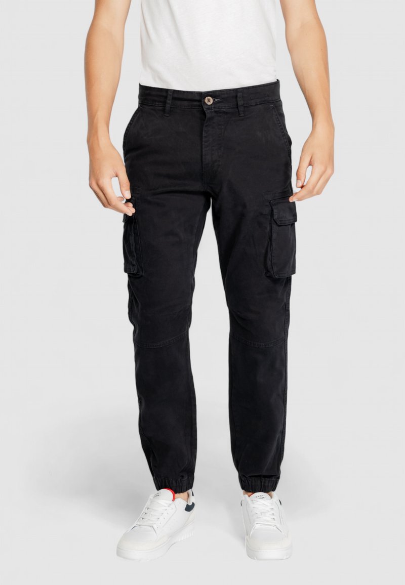 Pantaloni cargo neri con polsini elastici, numerose tasche laterali e chiusura a bottone. Realizzati in cotone con una superficie liscia.