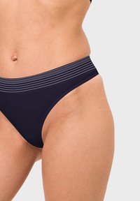 Navy blue bikini bottom featuring a wide striped waistband, smooth texture, and a low-rise cut designed for comfort and fit.