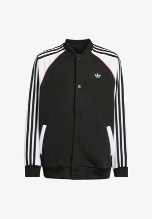 Musta takki nappisuljella, valkoisilla ja punaisilla yksityiskohdilla, sekä kolme pystysuoraa valkoista raitaa kussakin hihassa. Sisältää sivutaskut.