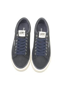 Pair of navy blue GANT sneakers with white rubber soles, navy laces, and branded labels on tongue and sides, viewed from above.