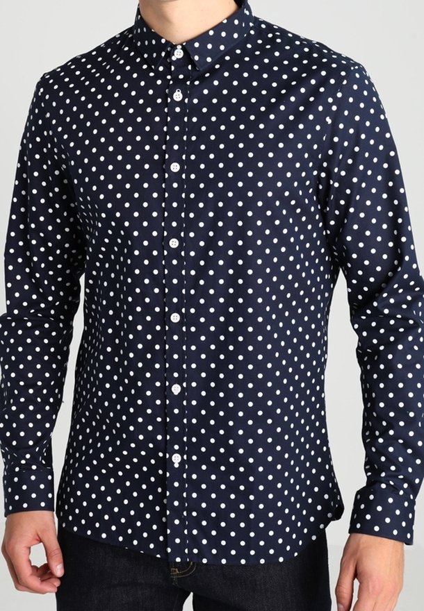 Navy blouse met witte stippen, lange mouwen en een klassieke kraag. Heeft een gladde textuur en een reguliere pasvorm.