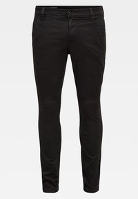 Černé slim-fit kalhoty vyrobené z bavlny, s předními kapsami, zapínáním na knoflík a hladkou texturou. Minimalistický design bez vzorů.
