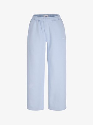 Helehallid laia lõikega dressipüksid elastse vöökohaga ja väikese valge logoga paremal reiel.