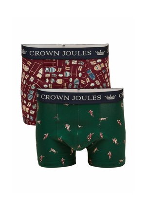 Dos pares de bóxers Crown Joules, uno verde con jugadores de rugby, el otro burdeos con patrón de equipamiento de rugby, ambos con cinturillas en azul marino.