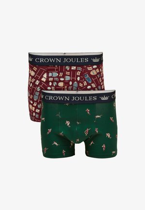 Dos pares de bóxers Crown Joules, uno verde con jugadores de rugby, el otro burdeos con patrón de equipamiento de rugby, ambos con cinturillas en azul marino.