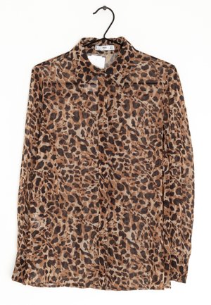 Leopard print blouse, sheer fabric, brown and black spots, classic collar, long sleeves, front button closure, hanging from a black hook.
