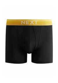 Boxer-briefs noirs avec une ceinture jaune portant le texte "NEXT." Fabriqués en matériau doux, conçus pour le confort et un bon ajustement.