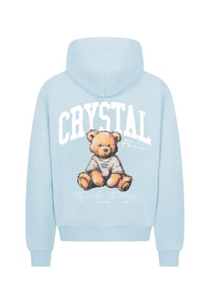 Svetle modrá mikina s kapucí s grafikou medvídka a nápisem "CRYSTAL Paris" a "Still Gentle. Still Strong" v kontrastní bílé a černé barvě.
