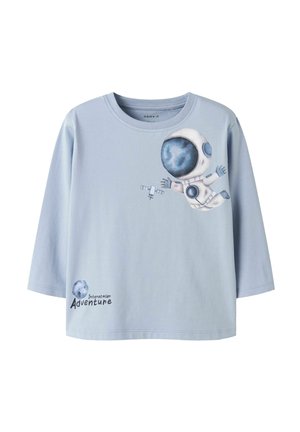 Light blue long-sleeve shirt with a floating astronaut, a satellite, a moon, and the text "Interstellar Adventure" on the front.