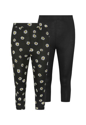 Deux paires de leggings : l'une noire avec un motif de marguerites blanches et l'autre noire unie, toutes deux fabriquées en tissu extensible et lisse.