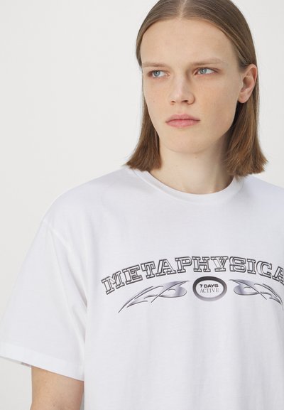 White cotton t-shirt featuring a black graphic print that reads "METAPHYSICAL" with curved accents and a "7 DAYS ACTIVE" logo.