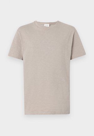 Lysebeige t-skjorte med korte ermer i myk, teksturert stoff. Har rund hals og diskret logo ved kanten.