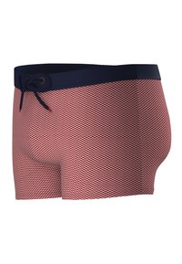 Short de bain à motifs en zigzag rouge et blanc avec une taille solide marine et un cordon de serrage ajustable. Tissu extensible pour le confort et l'ajustement.