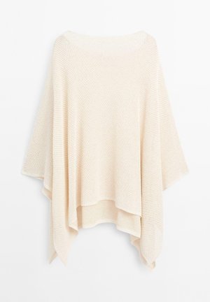 Poncho en maille beige avec un design ouvert, présentant une forme lâche et fluide ainsi qu'un tissu texturé. Les bords sont légèrement plus longs, créant un effet drapé.