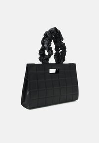 Borsa nera con un design trapuntato testurizzato, caratterizzata da una maniglia a forma rettangolare e una maniglia arricciata realizzata con materiale simile.