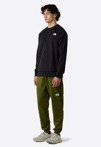The North Face M REAXION FLEECE JOGGER - EU - Trainingsbroek - woodland green