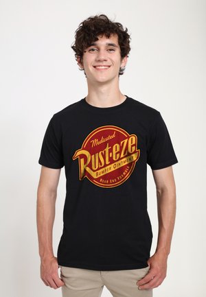 Black t-shirt featuring a prominent circular Rust-eze logo in red and gold, with text about a bumper ointment, and short sleeves.