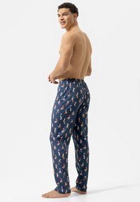 Navyblauwe pyjamabroek met een all-over print van kleurrijke cartoonfiguren, voorzien van een elastische tailleband en een losse pasvorm.