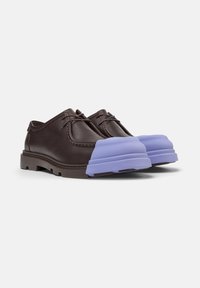 Brown leather shoes with a distinct lavender rubber toe cap, featuring a classic lace-up design and rugged sole.