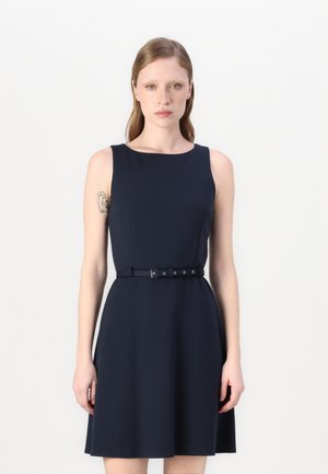 Navy blue sleeveless dress with a fitted bodice, flared skirt, and a matching belt featuring silver hardware and multiple holes.