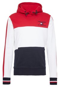 Bluza z kapturem w czerwono-białe i granatowe panele, z przednią kieszenią typu kangur i kontrastującymi ściągaczami z czerwonymi i białymi paskami.