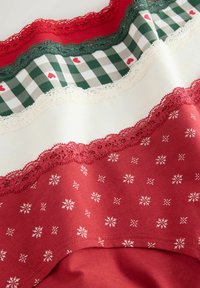 Red and green fabric with lace trims, checkered pattern with small hearts, and white snowflake prints on the lower section.