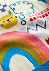 Multicolored knitted sweater featuring a yellow cat, cloud, and rainbow patterns. Primary colors include cream, pink, blue, and green.