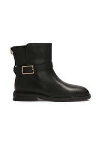 Black leather ankle boot with a smooth texture, rectangular buckle accent, and a low heel. Designed with a minimalist profile and ankle height.