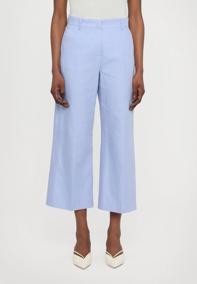 Light blue wide-leg trousers made of linen with a smooth texture. Features a mid-rise waist and subtle front crease details.