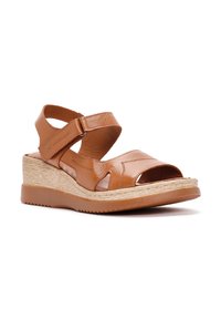 Sandali wedge in pelle marrone con punta aperta, cinturino regolabile e suola testurizzata. Presentano una piattaforma in fibra naturale per un'altezza aggiuntiva.