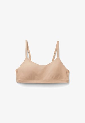 Bralette beige clair avec de fines bretelles réglables, texture lisse, décolleté rond et bords sans coutures pour un confort optimal et une visibilité minimale.