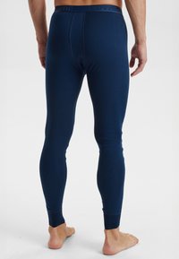 Marineblå leggings lavet af blødt stof, med en tætsiddende pasform, lang længde og en elastisk talje med et tekstureret logo.