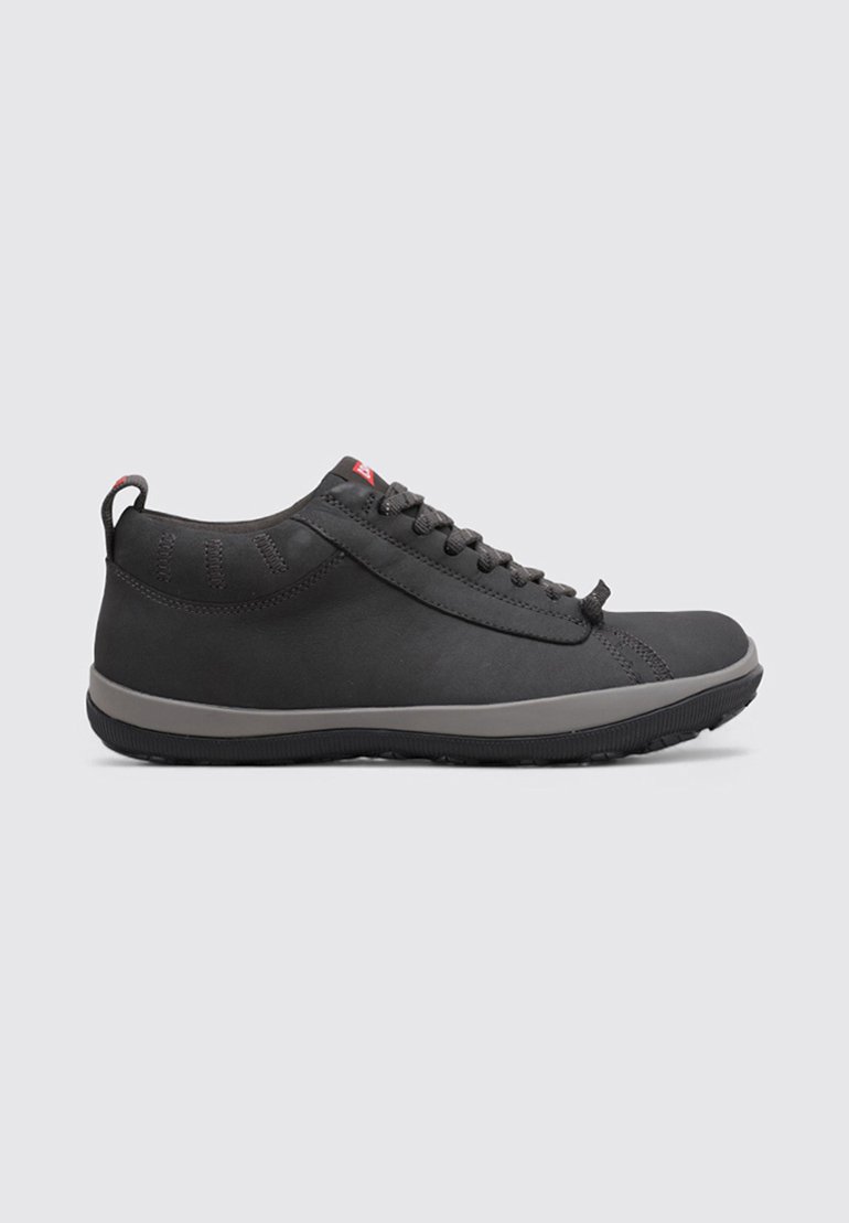 Black athletic shoes with a smooth upper, contrasting gray sole, round toe, and subtle stitching detail. Features textured heel tab for easy wear.