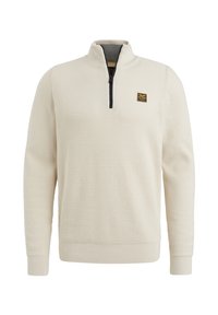 Crème half-zip trui met een gestructureerd wafelbreisel, voorzien van een zwarte rits en een klein logo-opdruk op de borst. Lange mouwen.