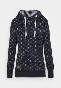 Sweat à capuche bleu marine avec motif d’ancre blanc, cordons blancs avec perles en bois, doublure intérieure rayée de la capuche et manches longues avec poignets côtelés.