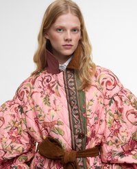 Quilted jacket in pink with floral patterns, green accents, and a brown corduroy belt. Features a high collar and oversized puff sleeves.