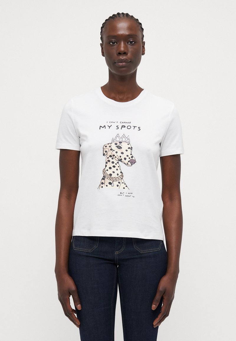 White cotton t-shirt featuring a graphic of a dog with spots, wearing a crown and necklace, and the text "I CAN'T CHANGE MY SPOTS."