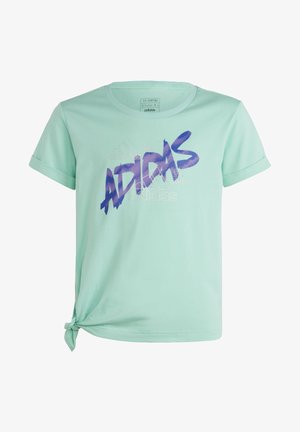 Mentolově zelené bavlněné tričko s ohrnutými rukávy, s fialovým grafickým designem "ADIDAS" a uzlovým detailem v levém dolním rohu.
