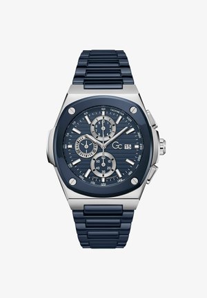 Marineblå kronografur med struktureret urskive, sølvfarvede detaljer og gummirem. Har under-Ure, tachymeter og metalhus.