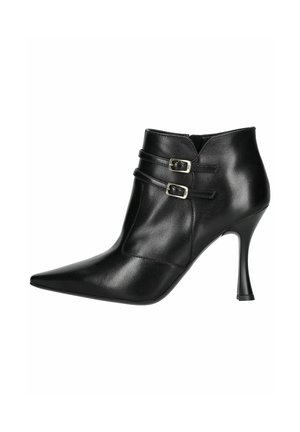 Black leather ankle boot with pointed toe, two buckle accents on the side, and a moderate stiletto heel. Smooth texture and streamlined design.