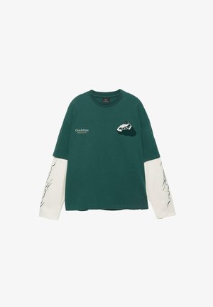 Donkergroen shirt met lange mouwen en witte gelaagde mouwen, bergafbeelding op de borst, "Quickdraw" tekst aan de linkerkant en zwarte golvende prints op de mouwen.