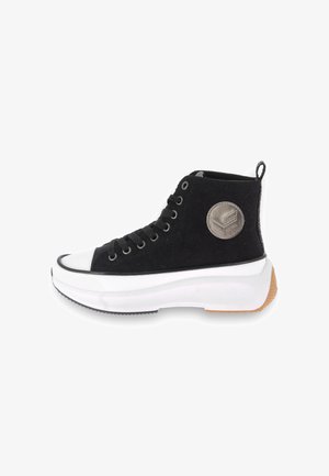 High-top sneakers with a black corduroy upper, white rubber toe cap, and a textured white midsole. Features a logo patch and black laces.