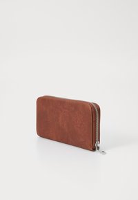 Brown leather wallet with embossed floral patterns, rectangular shape, zip-around closure, and silver hardware detailing.