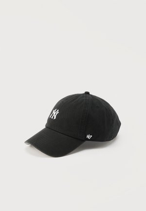 Black baseball cap with white New York Yankees logo on front and '47 brand embroidery on side, displayed on plain white background.